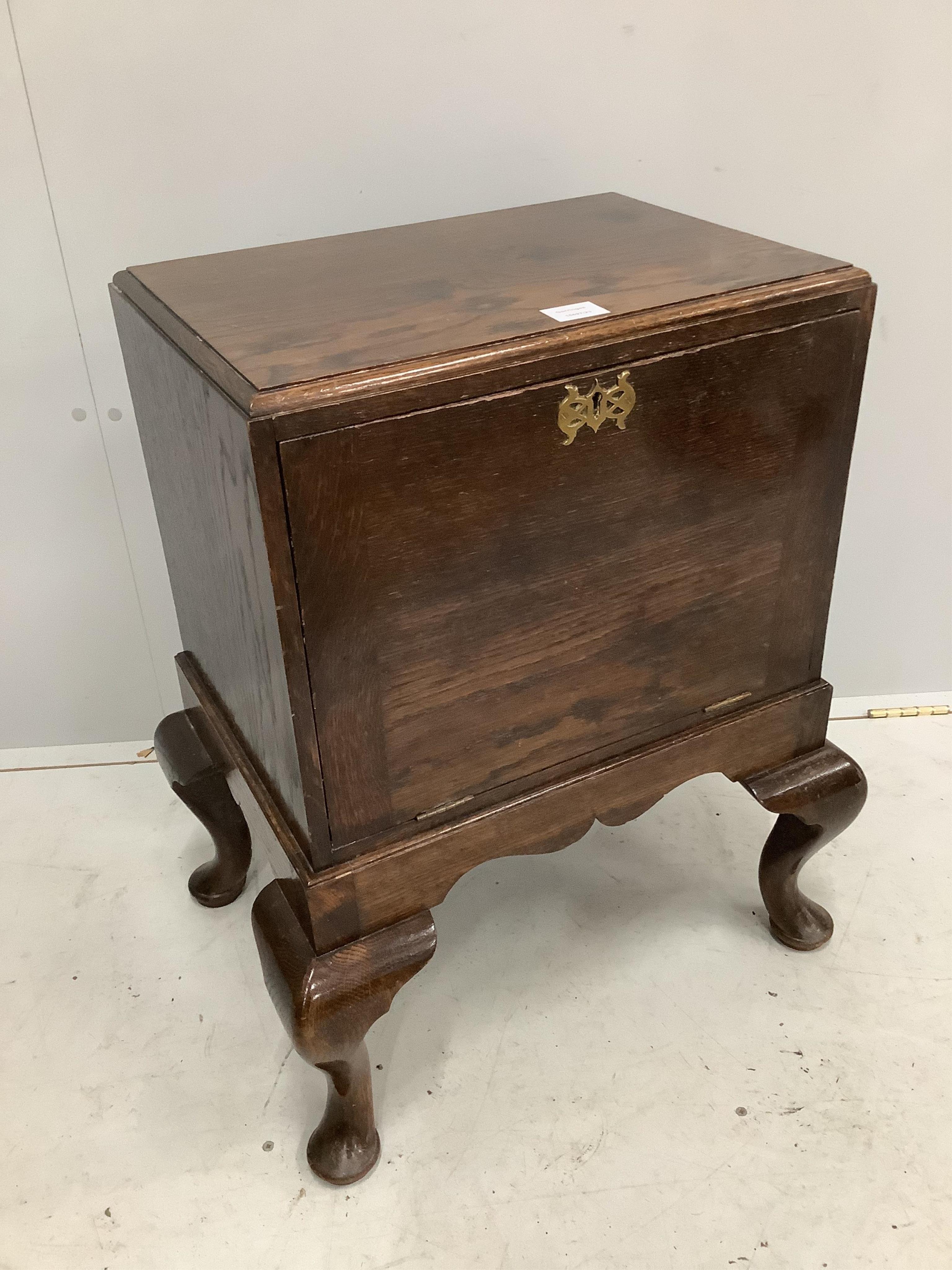 An early 20th century George II style oak record cabinet on cabriole legs, width 59cm, depth 45cm, height 71cm. Condition - fair